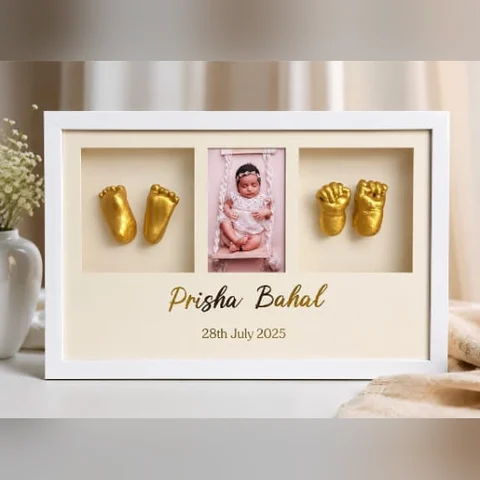 Baby hand and feet casting in gold with photo, name and birth date in a white frame by Jhilmil Decor