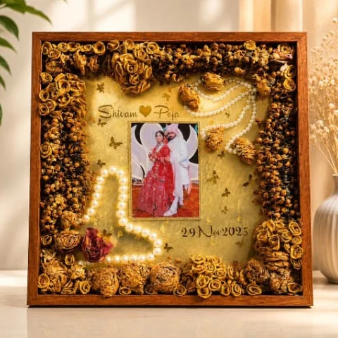 Teakwood varmala frame by Jhilmil Decor with preserved roses, pearls, the couple photo, names and wedding date
